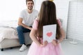 Father`s day. Happy family daughter giving dad a greeting card on holiday. Royalty Free Stock Photo