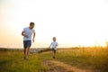 Father's day. Happy family father and toddler son playing and laughing on nature at sunset Royalty Free Stock Photo