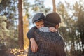 Father`s day. Sad son hugging dad on the  forest background  with copy space. Concept of father-son relationship Royalty Free Stock Photo
