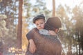 Father`s day. Sad son hugging dad on the  forest background  with copy space. Concept of father-son relationship Royalty Free Stock Photo