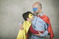 Father`s day,father and son dressed as a superhero