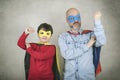 Father`s day,father and son dressed as a superhero