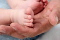 Father's hand and babies feet Royalty Free Stock Photo