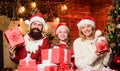 Father Santa claus costume with family celebrating christmas. Lovely daughter with parents wearing Santa hat. Gifts from