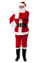 Father Santa pointing towards the copy space area Royalty Free Stock Photo