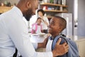 Father Saying Goodbye To Son As He Leaves For School