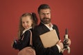 Father and schoolgirl with proud and happy faces on terracotta