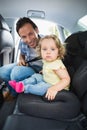 Father securing his baby in the car seat Royalty Free Stock Photo
