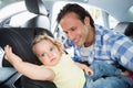 Father securing his baby in the car seat Royalty Free Stock Photo