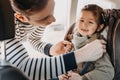 Father securing his toddler daughter buckled into her baby car seat Royalty Free Stock Photo