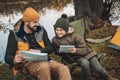 Father showing something to son on a map sitting