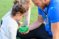 The father shows the caterpillar to the children Royalty Free Stock Photo