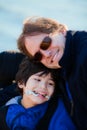 Father sitting with disabled son along lake shore Royalty Free Stock Photo