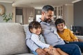 Father sitting with kids on couch Royalty Free Stock Photo