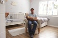 Father Sitting In Nursery Chair Holds Sleeping Baby Son Royalty Free Stock Photo