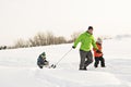 A cool Father drag his boy in sled Royalty Free Stock Photo