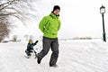 A nice Father drag his boy in sled Royalty Free Stock Photo