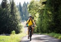 Father with small child cycling outdoors in summer nature, High Tatras in Slovakia. Royalty Free Stock Photo