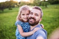 Father with a small daughter having fun in spring nature, taking selfie. Royalty Free Stock Photo