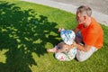 Father with a small daughter relax on a green meadow Royalty Free Stock Photo