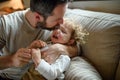 Father with small sick crying toddler daughter indoors at home.