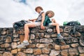 Father and son backpacker traveler rest together sitting on old