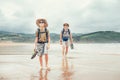 Father and son backpacker traveler walk on sand ocean beach