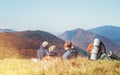 Father with son backpackers hikers resting on mountain hill and enjoying Low Tatras landscape with their beagle dog. Mountain