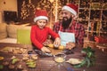 Father and son baking gingerbread Christmas cookies.