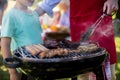 Father and son barbequing in the park