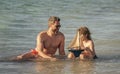 Father son beach adventure playing with toy ship. creating memories. Beachside bonding between father and son. playing Royalty Free Stock Photo