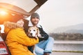 Father and son with beagle dog siting together in car trunk and Royalty Free Stock Photo