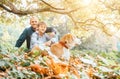 Father, son and beagle dog walk in autumn park, warm indian summer day Royalty Free Stock Photo