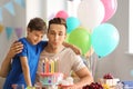Father and son with birthday cake at party Royalty Free Stock Photo