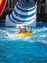 Funny pose after riding down the large water slide Royalty Free Stock Photo