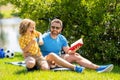 Father and son bonding over outdoor literature. Father and son explore book in nature beauty. quality time for father