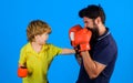 Father and son boxing. Little child boxer with coach at boxing training. Boy and trainer in boxing gloves. Child and