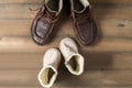 Father and son brown leather boots shoes on wooden