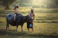 Father and son with a buffalo this lifestyle Thai people in Countryside Thailand.