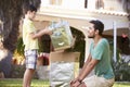 Father And Son Building Model Robot In Garden