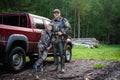 Father and son came to the forest for hunting together. Standing with a shotgun rifle in front of pickup truck. Royalty Free Stock Photo