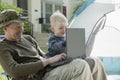Father and son camping with laptop Royalty Free Stock Photo