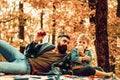 Father and son camping. Man with beard, dad with young son in autumn park. Happy joyful father with a cute son vacation Royalty Free Stock Photo