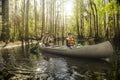 Father and son canoeing together in a tropical river