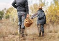 Father and son carry full basket of mushrooms Royalty Free Stock Photo