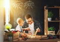 Father and son carved of wood in carpentry workshop Royalty Free Stock Photo