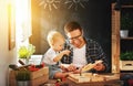 Father and son carved of wood in carpentry workshop Royalty Free Stock Photo