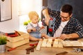 Father and son carved of wood in carpentry workshop Royalty Free Stock Photo