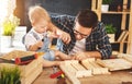 Father and son carved of wood in carpentry workshop Royalty Free Stock Photo