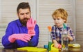 Father and son cleaning. Dad teaching kid little boy use disinfectant spray cleaning and washing dust while cleaning